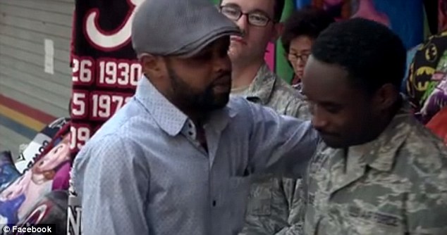 Enyioko (pictured hugging the soldiers) said he was overwhelmed with gratitude to the airmen