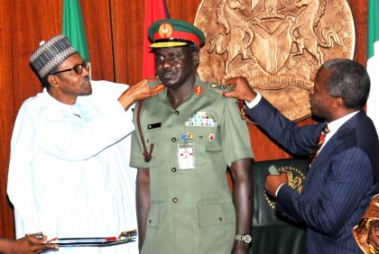 Buratai, middle being decorated by President Buhari, left and VP Osinbajo (PHOTO: NAN)