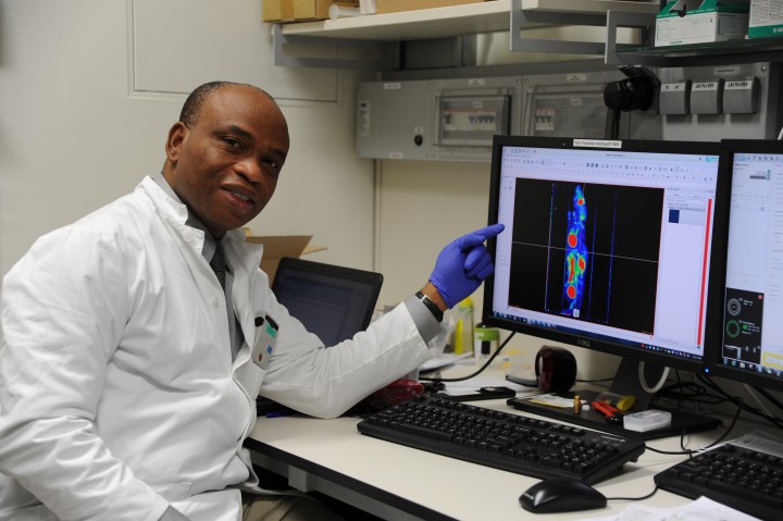 Academician Dr Philip Njemanze looking and PET image of experimental mice